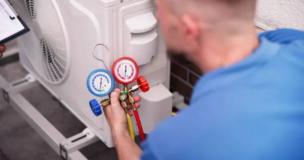 a man holding a pressure gauge